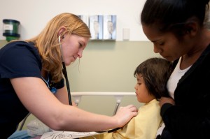 A Maricopa Integrated Health System physicians attends to a child in the emergency department of the Arizona Children’s Center in Phoenix.